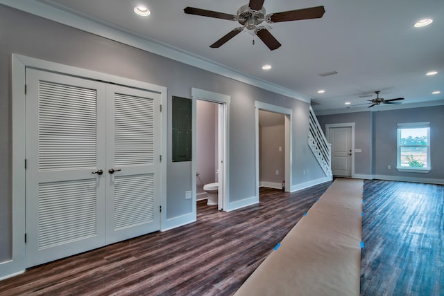 unfurnished living room featuring dark hardwood / wood-style flooring, crown molding, electric panel, and ceiling fan