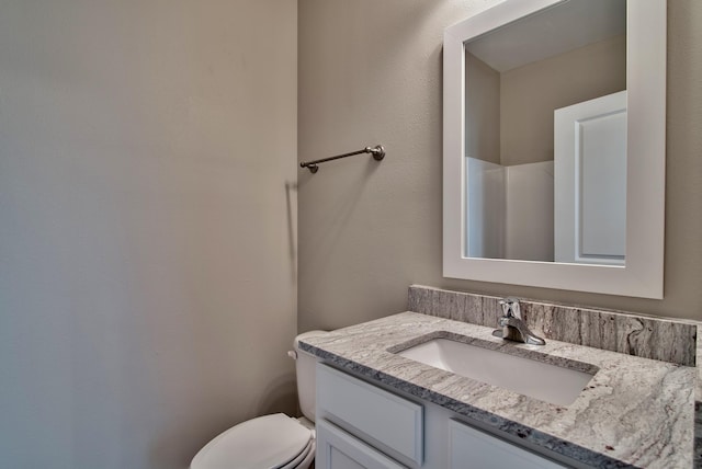 bathroom with toilet and vanity