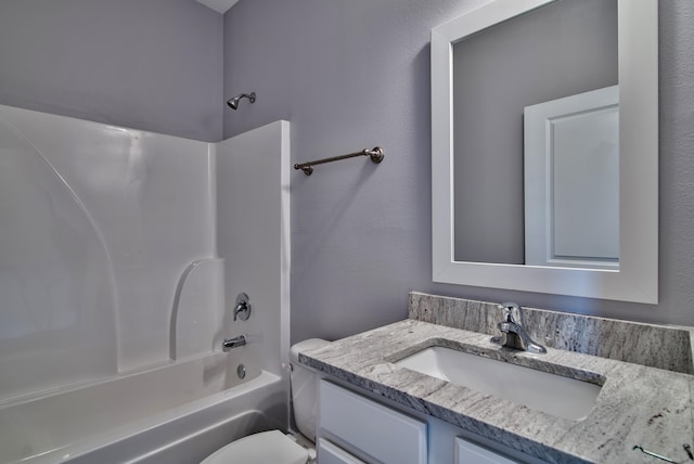 full bathroom with bathing tub / shower combination, toilet, and vanity