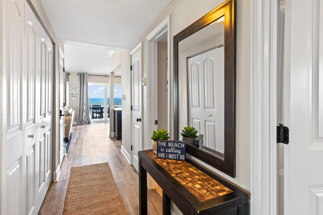 corridor with hardwood / wood-style floors