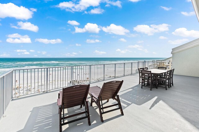 view of patio featuring a balcony and a water view