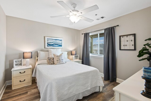 bedroom with ceiling fan and dark hardwood / wood-style floors