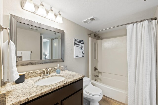 full bathroom featuring tile patterned flooring, toilet, shower / tub combo with curtain, and vanity