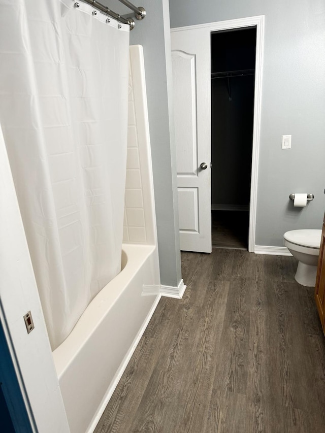 bathroom featuring hardwood / wood-style floors, shower / tub combo, and toilet