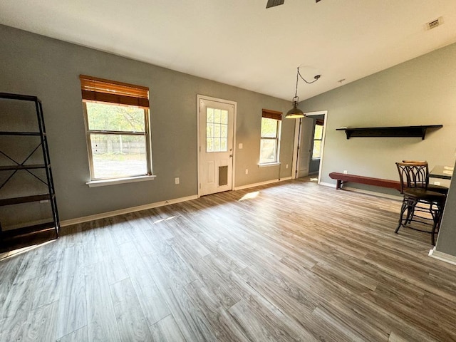 unfurnished living room with hardwood / wood-style flooring and lofted ceiling