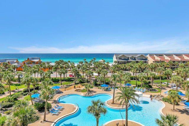 community pool featuring a patio and a water view