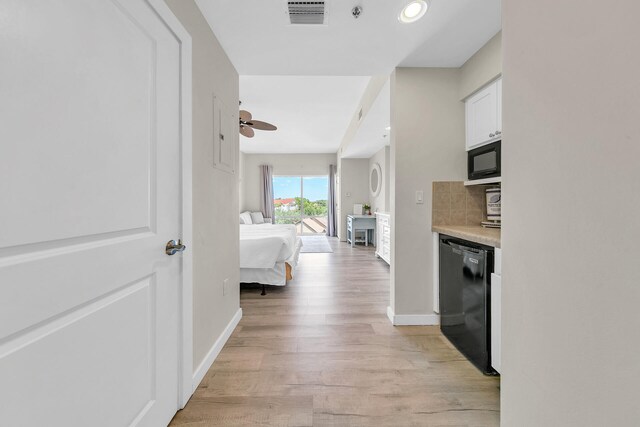 kitchen featuring ceiling fan, black appliances, backsplash, and light hardwood / wood-style flooring