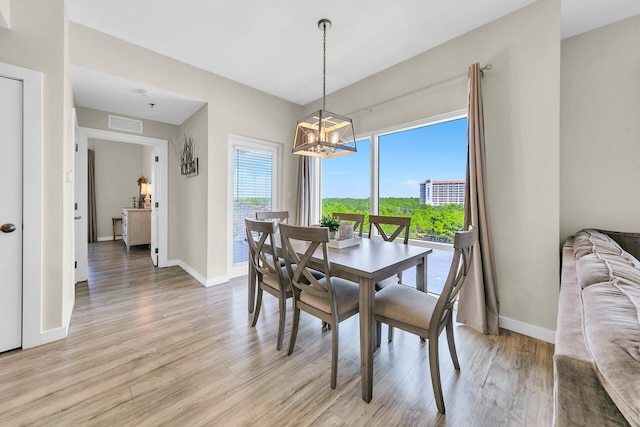 dining room featuring light hardwood / wood-style floors and an inviting chandelier