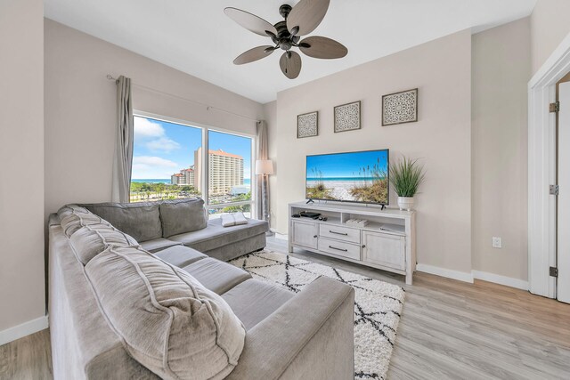 living room with ceiling fan and light hardwood / wood-style floors