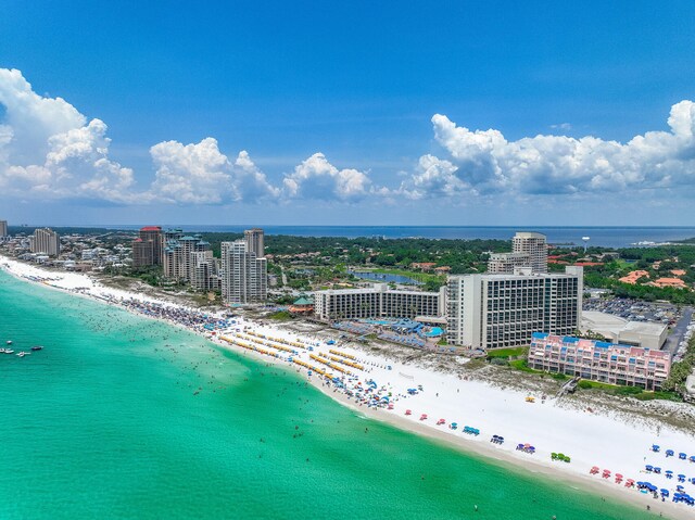 drone / aerial view featuring a beach view and a water view