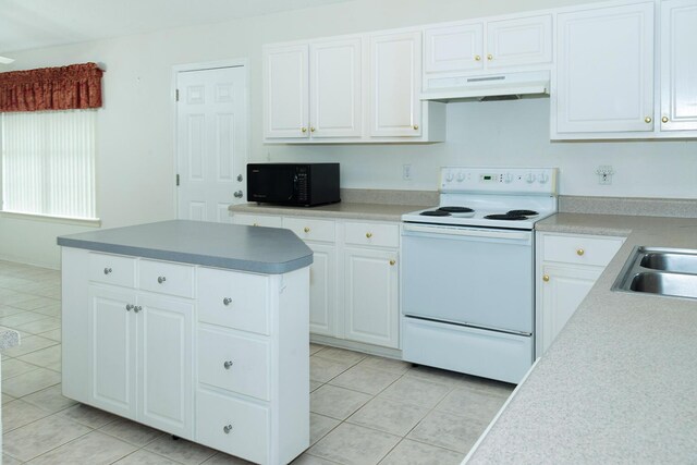 kitchen featuring white cabinets, a center island, light tile patterned flooring, and white electric range oven