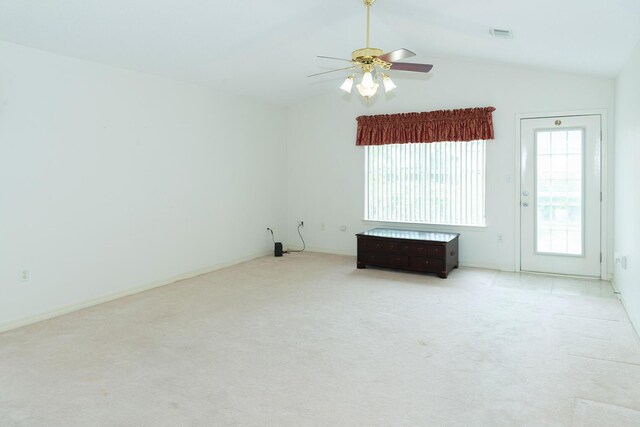 unfurnished room featuring lofted ceiling, ceiling fan, and light carpet