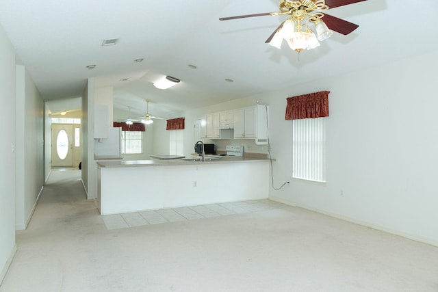 kitchen featuring white appliances, white cabinetry, plenty of natural light, and ceiling fan