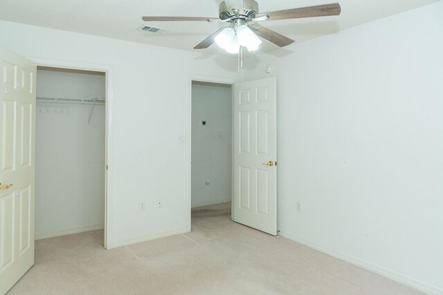 unfurnished bedroom with a closet, ceiling fan, and light carpet