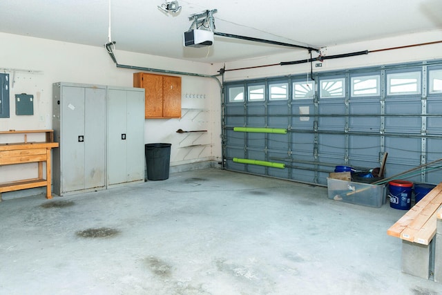 garage with a garage door opener and electric panel