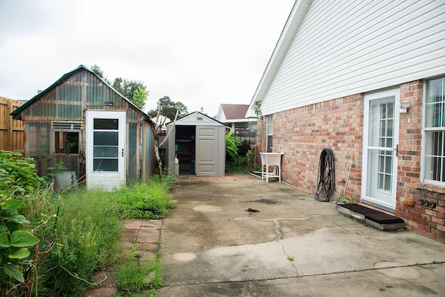 view of patio / terrace featuring a storage shed