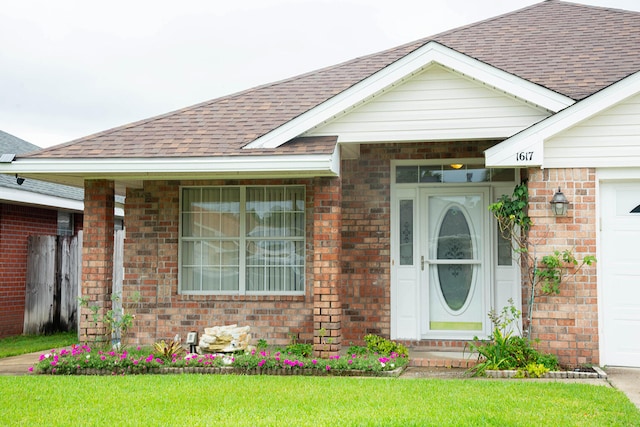 view of exterior entry with a lawn