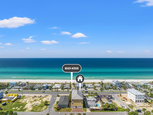 drone / aerial view featuring a water view and a view of the beach