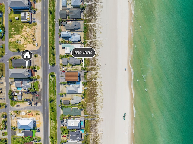 birds eye view of property featuring a beach view and a water view