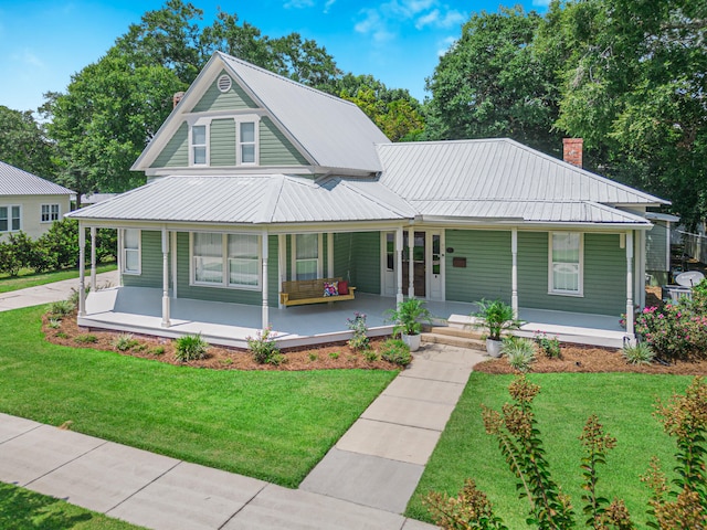 country-style home with a front lawn and covered porch