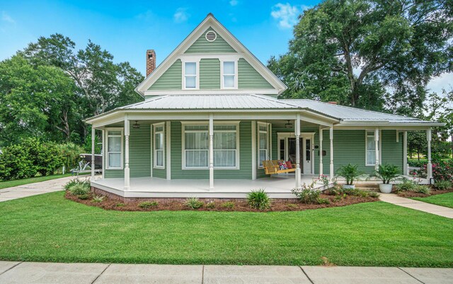 view of front of property with covered porch and a front lawn