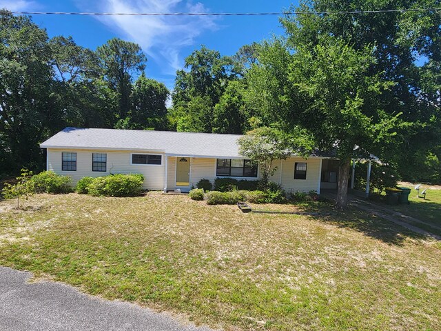 ranch-style home with a front lawn