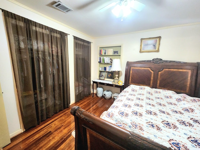 bedroom with ceiling fan, ornamental molding, and dark hardwood / wood-style flooring