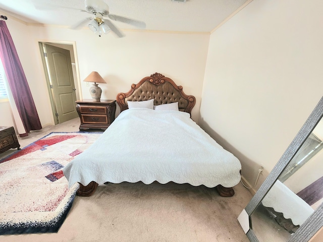 bedroom featuring crown molding, ceiling fan, and carpet flooring