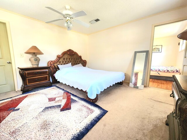 bedroom featuring ornamental molding, ceiling fan, and carpet