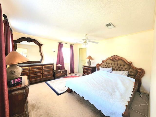 carpeted bedroom featuring a textured ceiling and ceiling fan