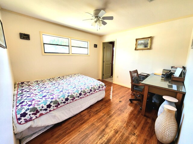 bedroom with crown molding, ceiling fan, and dark hardwood / wood-style floors