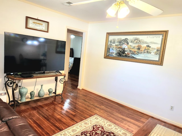 living room featuring crown molding, dark wood-type flooring, and ceiling fan