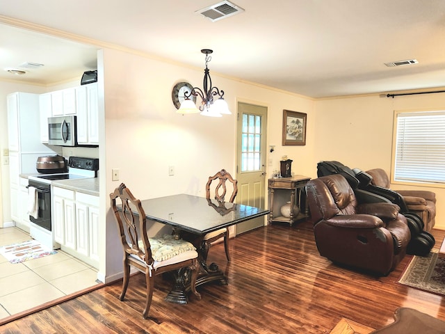 dining room with dark wood-type flooring and a chandelier