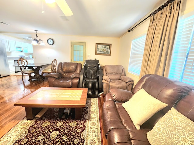 living room featuring ceiling fan and hardwood / wood-style flooring