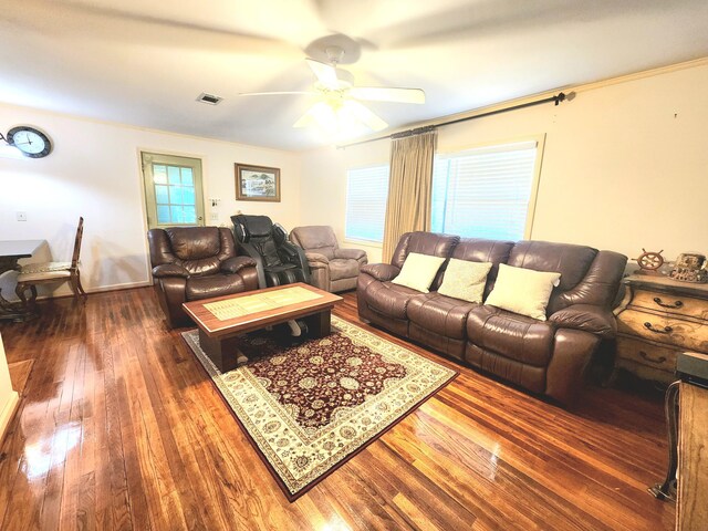 living room featuring ornamental molding, dark hardwood / wood-style flooring, a wealth of natural light, and ceiling fan