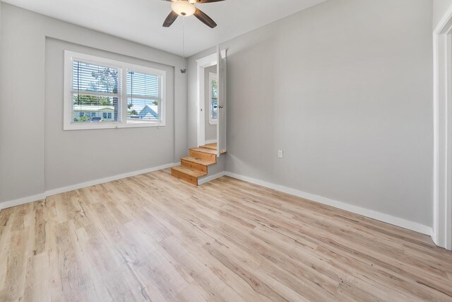 empty room featuring ceiling fan and light wood-type flooring