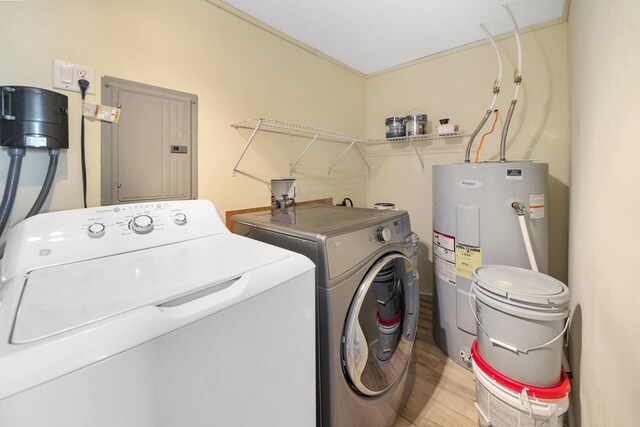 laundry room featuring light wood-type flooring, water heater, electric panel, and washer and clothes dryer