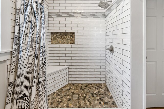 bathroom with a tile shower