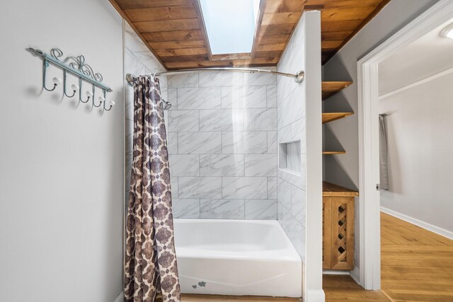 bathroom featuring wood ceiling, hardwood / wood-style floors, a skylight, and shower / tub combo