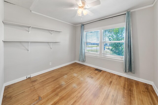 spare room featuring ceiling fan, light hardwood / wood-style floors, and crown molding