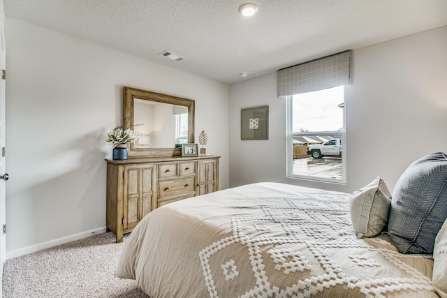 carpeted bedroom with a textured ceiling