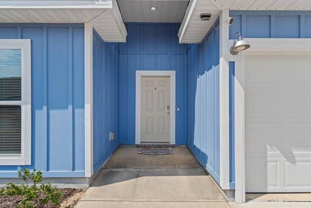 view of exterior entry with a garage