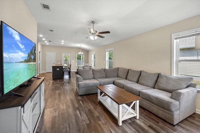 living room featuring ceiling fan, lofted ceiling, and dark hardwood / wood-style floors