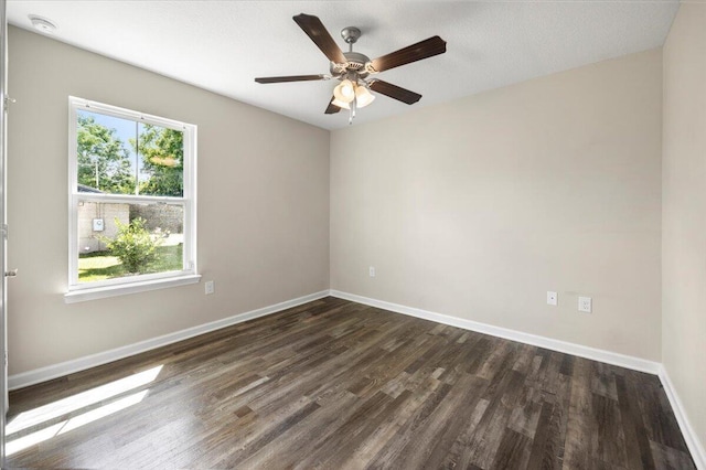 spare room with a textured ceiling, dark wood-type flooring, and ceiling fan