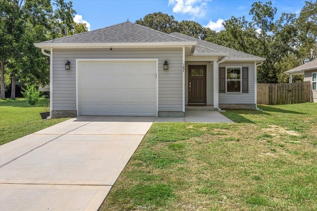 ranch-style house featuring a front yard and a garage