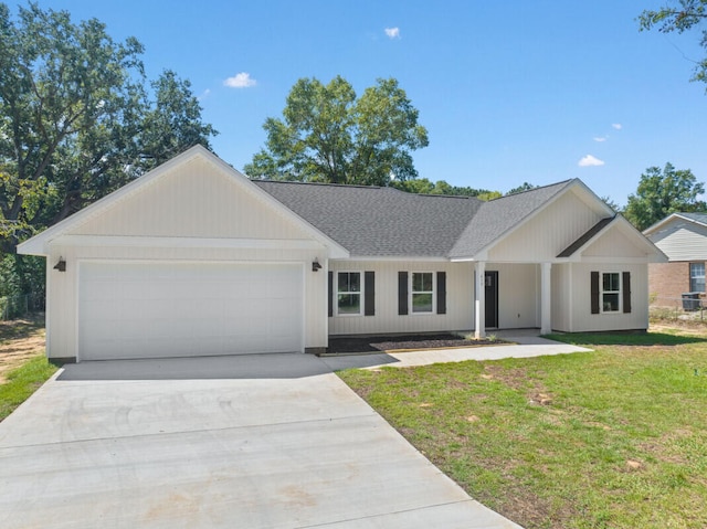 ranch-style home with central AC, a garage, and a front yard