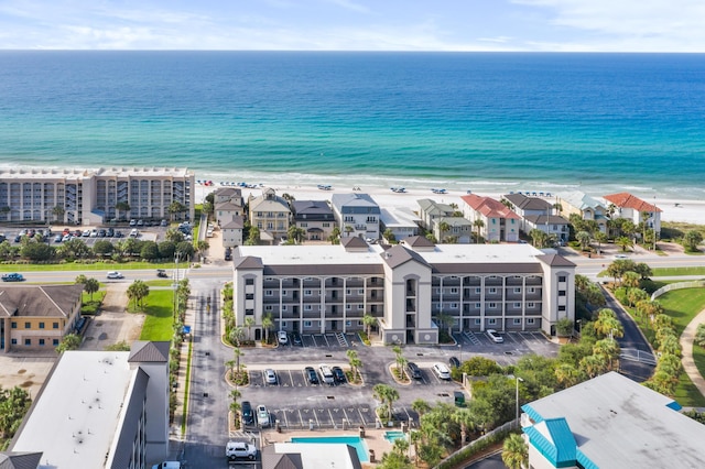 drone / aerial view with a water view and a view of the beach