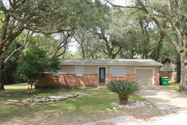 ranch-style house featuring a front yard and a garage