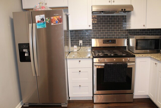 kitchen featuring white cabinets, appliances with stainless steel finishes, dark wood-type flooring, and extractor fan