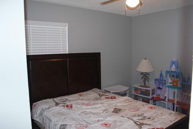 bedroom featuring a textured ceiling and ceiling fan